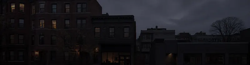 A mixed row of buildings at dusk.