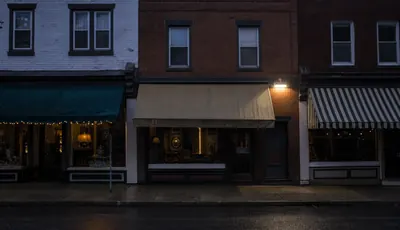 A row of small storefronts at dusk.